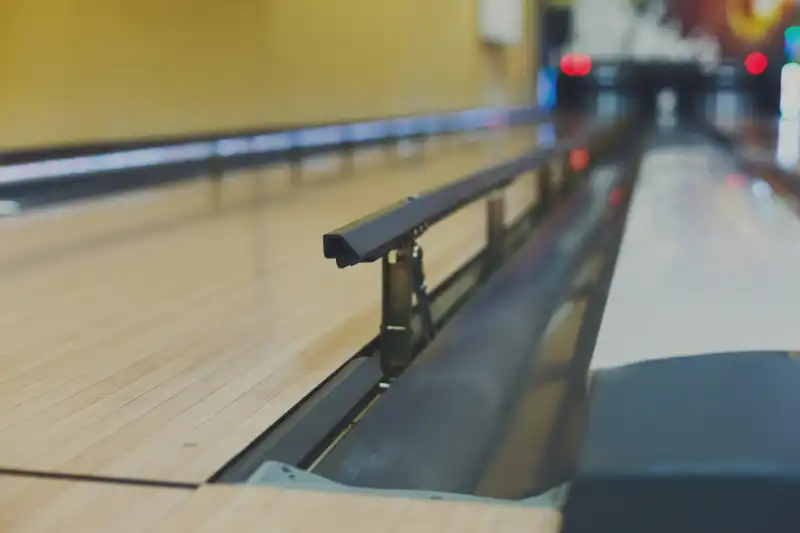 Bowling alley background. Lane with bumper rails closeup. Leisure activity club