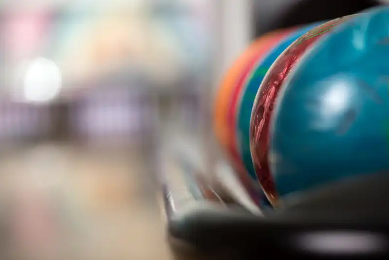 Focused ball on a colorful alley, anticipation for a thrilling bowling match